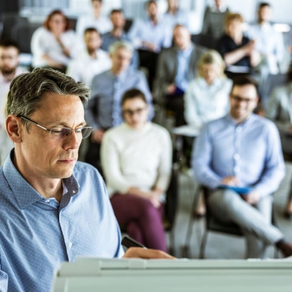 Mid adult entrepreneur having a presentation with his colleagues in a board room.