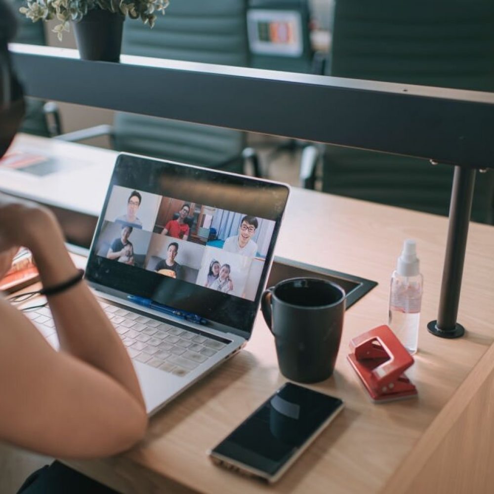 an asian chinese long hair woman having video conference call with her business partners in coworking office